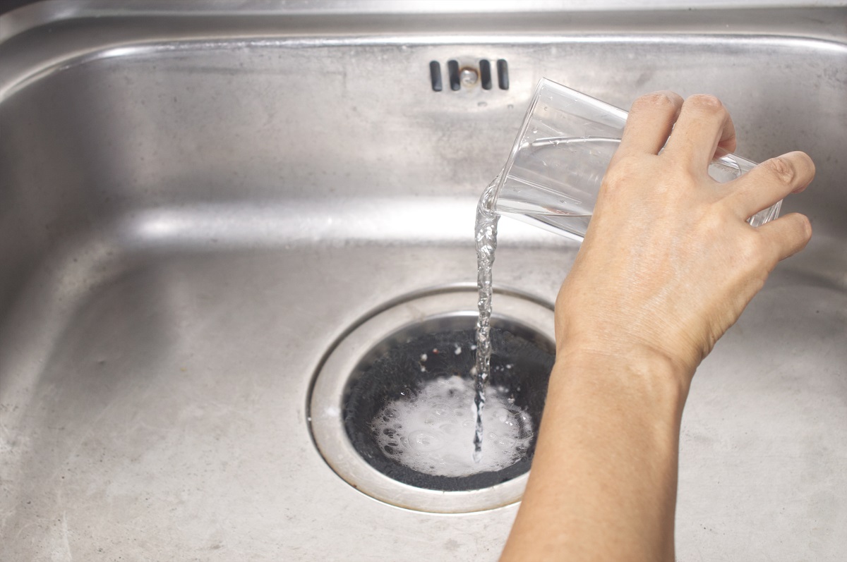 pour a spoon of baking soda and a glass of vinegar into the drain of the sink
