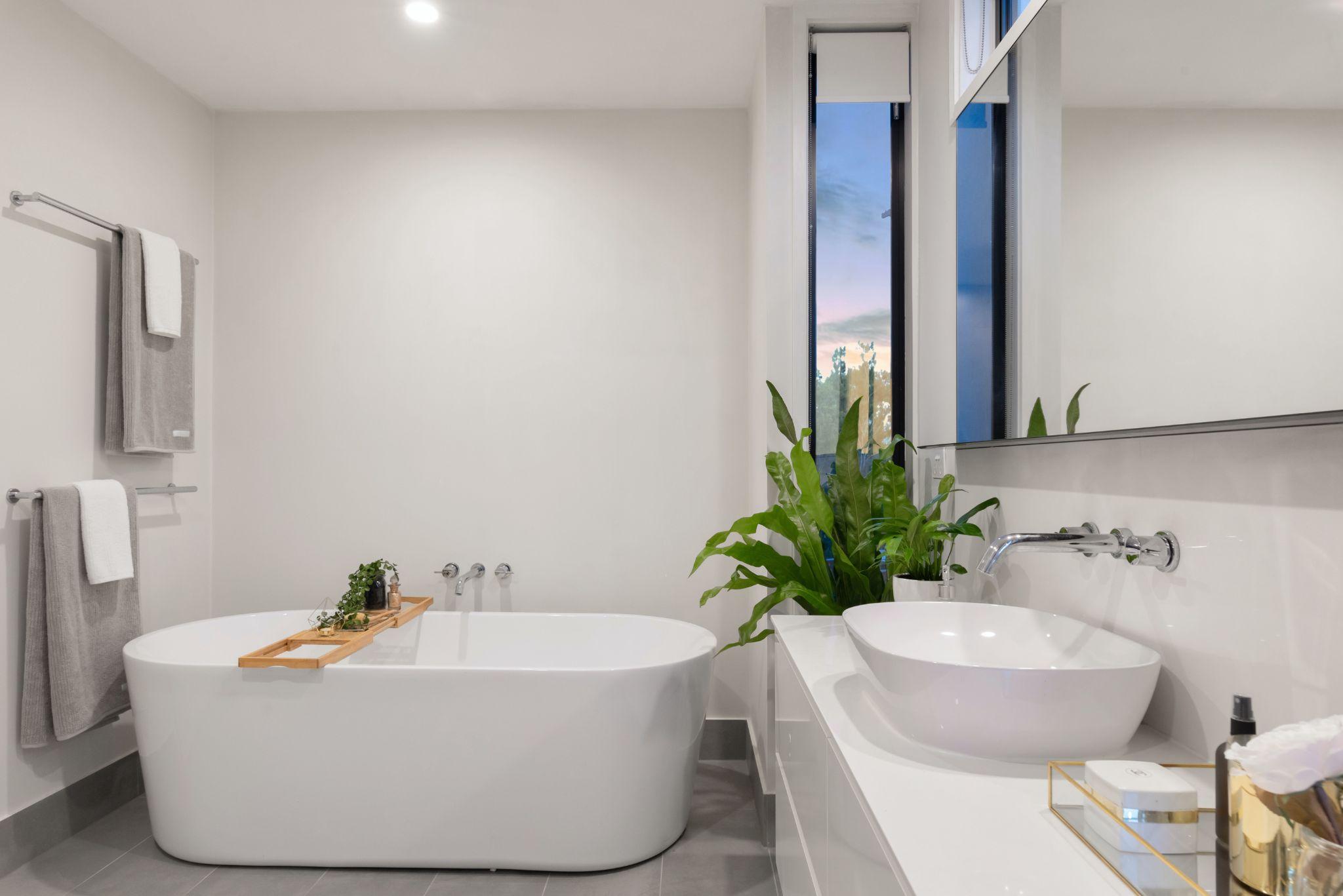 white Bathroom with Amenities, Bathtub and sink.
