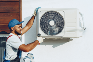 Professional plumber from Christianson Air Conditioning & Plumbing installing a new AC unit