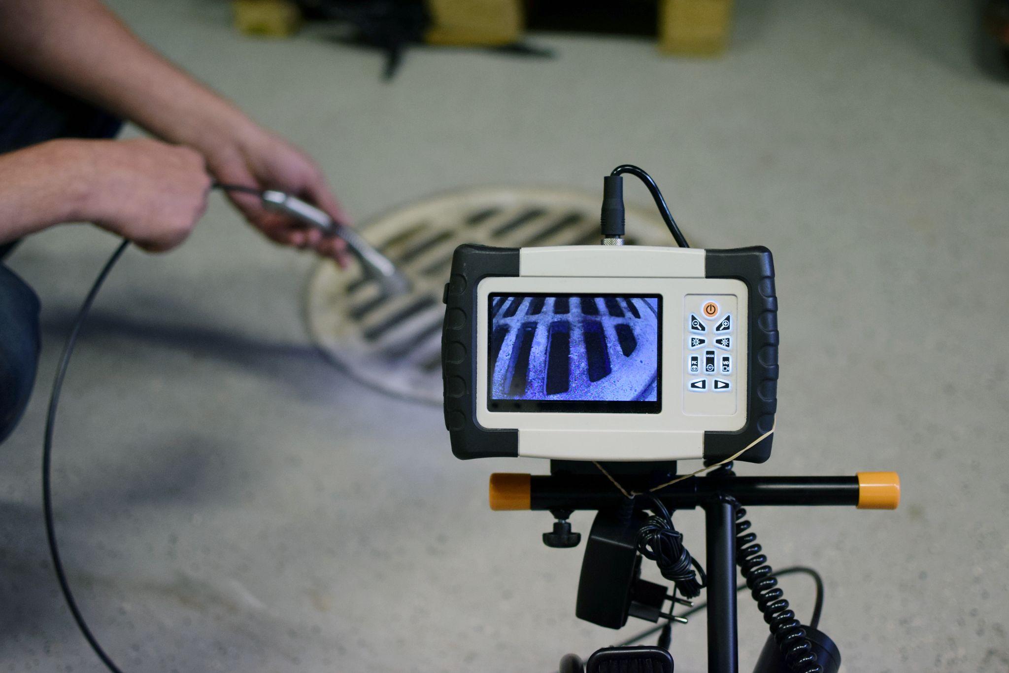 Plumber performing a drain camera inspection