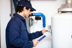 Plumber inspecting a water heater